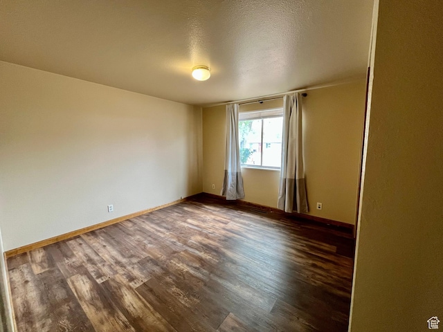 736 Westwood Ave, Moab, UT 84532 - empty room featuring baseboards and dark wood-style flooring