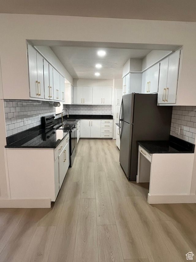 3374 Eccles E, Ogden, UT 84403 - kitchen featuring decorative backsplash, dark countertops, white cabinetry, and light wood-type flooring