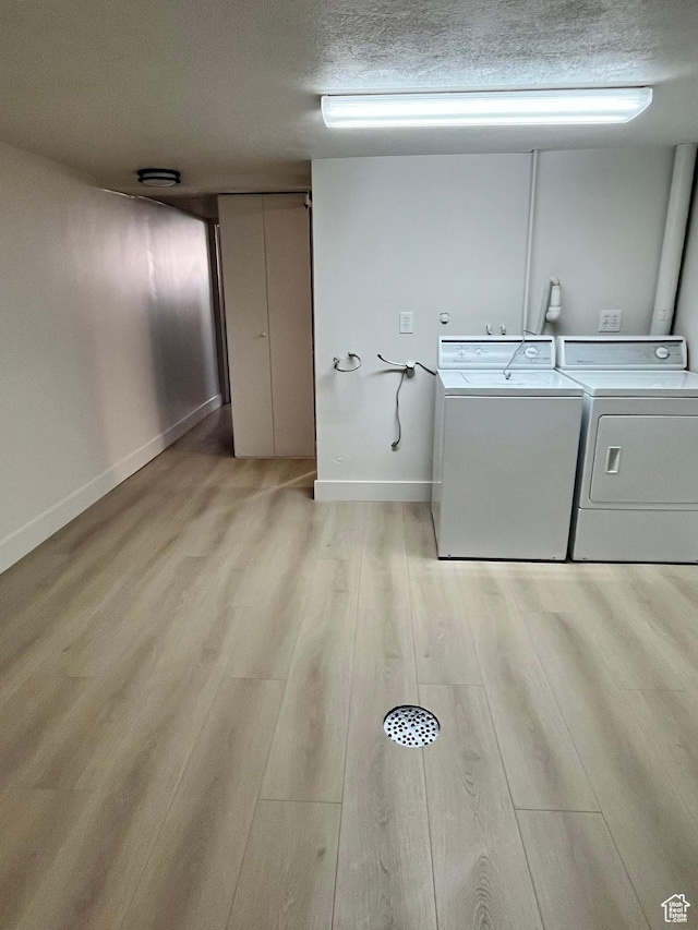 3374 Eccles E, Ogden, UT 84403 - laundry area featuring laundry area, washing machine and dryer, light wood-style floors, baseboards, and a textured ceiling