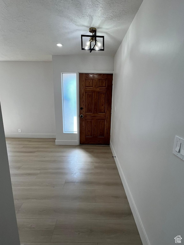 3374 Eccles E, Ogden, UT 84403 - entryway featuring a textured ceiling, light wood finished floors, and baseboards