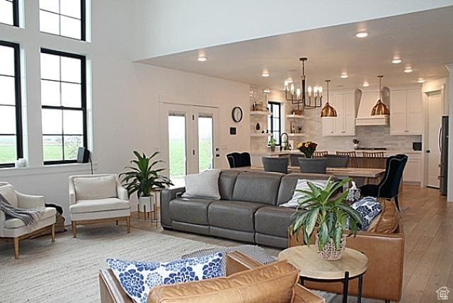 7226 Estancia Ln, Smithfield, UT 84335 - living area with light wood finished floors, a chandelier, and recessed lighting