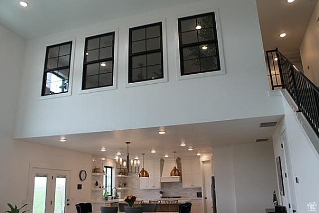 7226 Estancia Ln, Smithfield, UT 84335 - living area with a towering ceiling, recessed lighting, a chandelier, and stairway