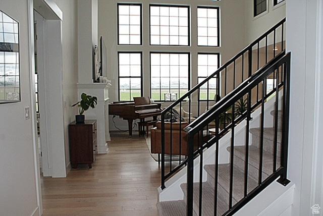7226 Estancia Ln, Smithfield, UT 84335 - stairs featuring wood finished floors, a high ceiling, and baseboards