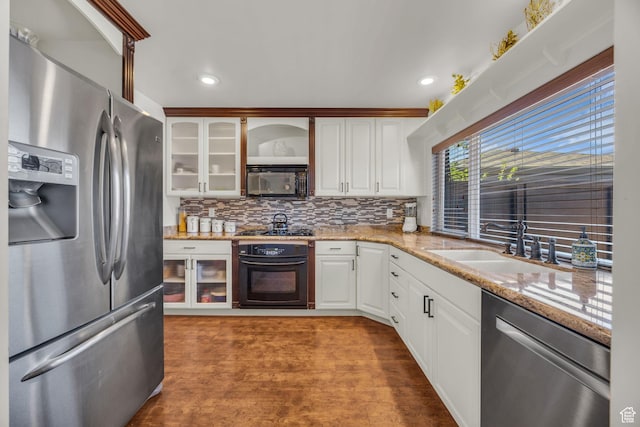 2251 Ridgewood Way, Bountiful, UT 84010 - kitchen featuring a sink, black appliances, glass insert cabinets, backsplash, and white cabinetry