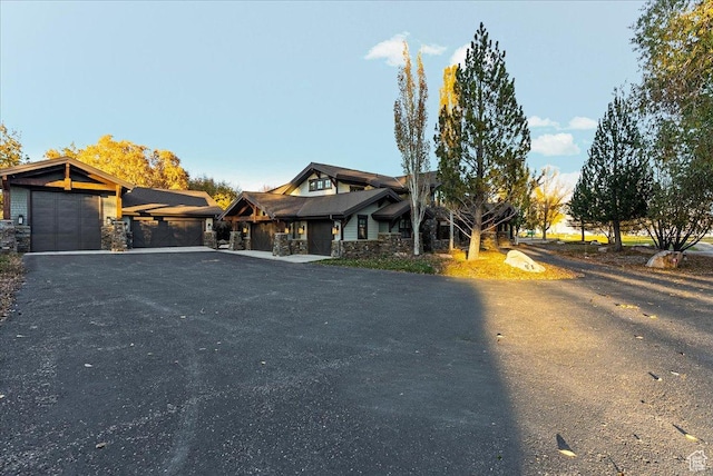57 E 445 S, Garden City, UT 84028 - view of front of home with an attached garage, driveway, and stone siding