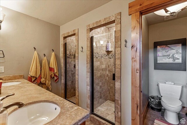 57 E 445 S, Garden City, UT 84028 - bathroom featuring a sink, a shower stall, double vanity, and toilet