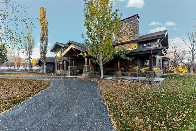 57 E 445 S, Garden City, UT 84028 - view of front of home with stone siding, a chimney, and curved driveway
