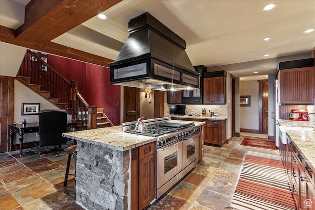 57 E 445 S, Garden City, UT 84028 - kitchen featuring tasteful backsplash, stone tile floors, island exhaust hood, and range with two ovens