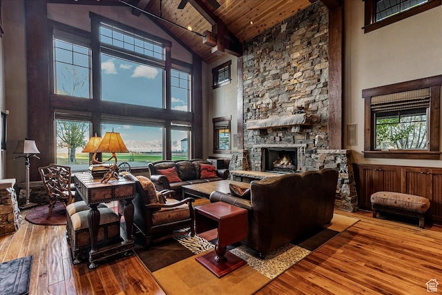 57 E 445 S, Garden City, UT 84028 - living area with high vaulted ceiling, a stone fireplace, hardwood / wood-style flooring, wood ceiling, and beam ceiling