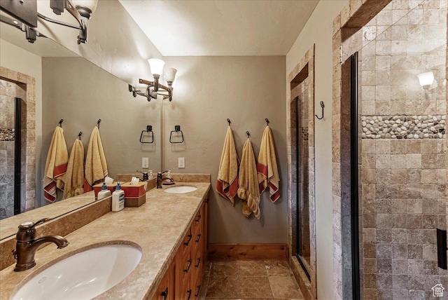 57 E 445 S, Garden City, UT 84028 - bathroom with double vanity, a shower stall, baseboards, and a sink