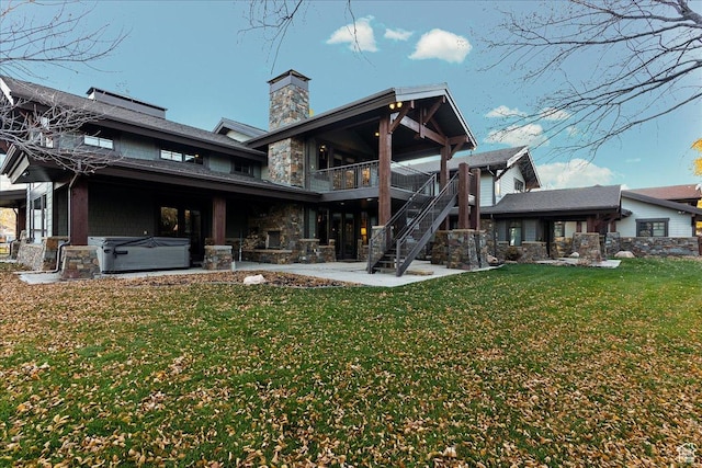 57 E 445 S, Garden City, UT 84028 - back of house with stairs, a yard, a patio, stone siding, and a hot tub