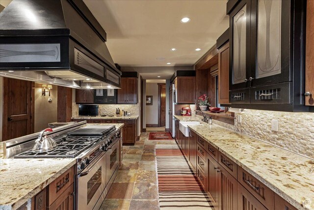 57 E 445 S, Garden City, UT 84028 - kitchen featuring recessed lighting, stone tile floors, a sink, double oven range, and tasteful backsplash