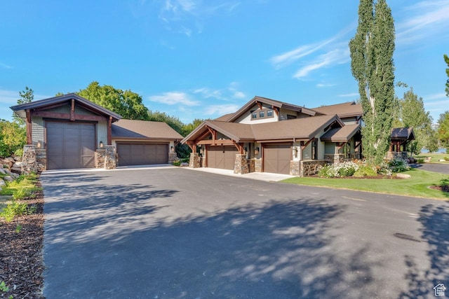 57 E 445 S, Garden City, UT 84028 - view of front of home with an attached garage, driveway, and stone siding