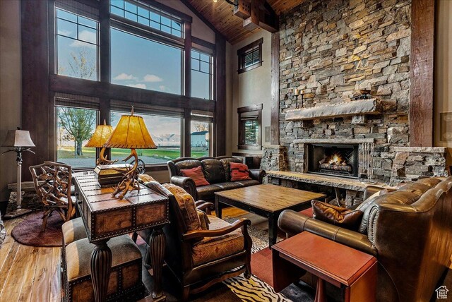 57 E 445 S, Garden City, UT 84028 - living room with high vaulted ceiling, a stone fireplace, wood finished floors, wood ceiling, and beam ceiling