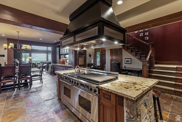 57 E 445 S, Garden City, UT 84028 - kitchen with stone tile floors, an inviting chandelier, recessed lighting, range with two ovens, and light stone countertops