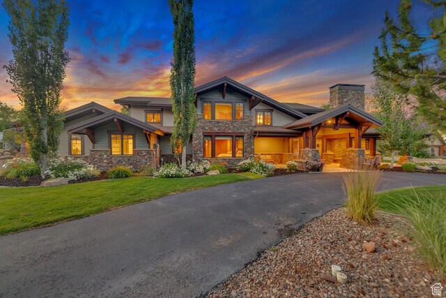 57 E 445 S, Garden City, UT 84028 - craftsman-style home featuring stone siding, a front lawn, aphalt driveway, and a chimney