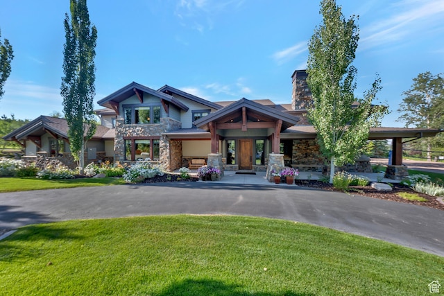 57 E 445 S, Garden City, UT 84028 - view of front of property with a chimney, stone siding, and a front yard