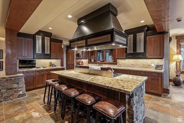 57 E 445 S, Garden City, UT 84028 - kitchen with stone tile flooring, decorative backsplash, a center island, and island exhaust hood
