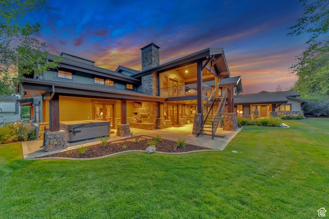 57 E 445 S, Garden City, UT 84028 - rear view of house with stairway, a yard, a patio area, stone siding, and a hot tub