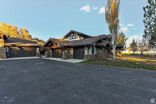 57 E 445 S, Garden City, UT 84028 - view of front facade with a garage, driveway, and stone siding