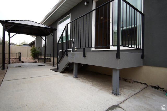 view of side of property with fence, a gazebo, and metal roof