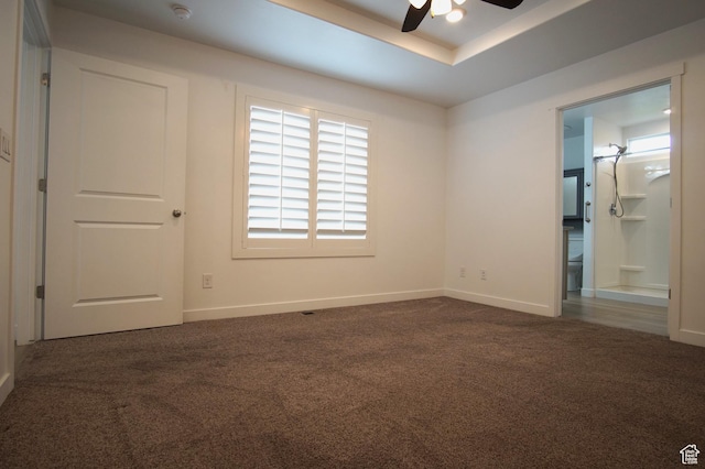 unfurnished bedroom featuring carpet floors, baseboards, and connected bathroom