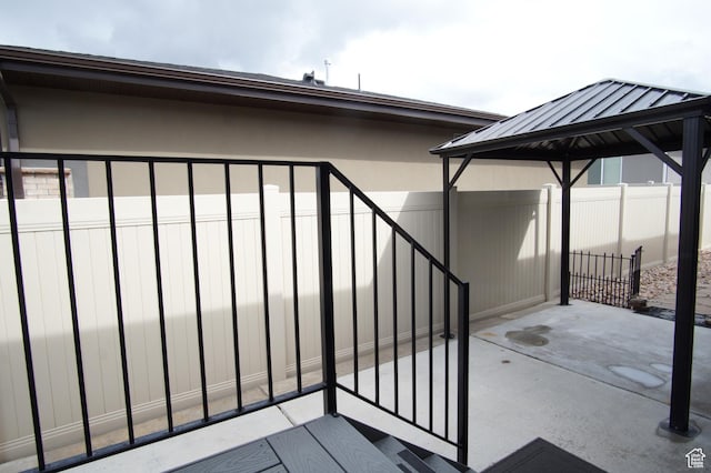 view of patio with a gazebo and fence