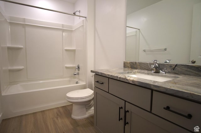 full bathroom with shower / bath combination, wood finished floors, toilet, and vanity