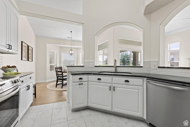 890 N Sky Mountain Ct, Hurricane, UT 84737 - kitchen featuring appliances with stainless steel finishes, a sink, light marble finish flooring, white cabinetry, and backsplash