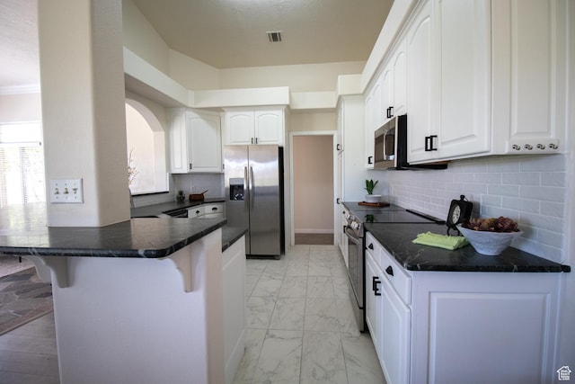 890 N Sky Mountain Ct, Hurricane, UT 84737 - kitchen with stainless steel appliances, a kitchen breakfast bar, light marble finish flooring, white cabinetry, and a peninsula