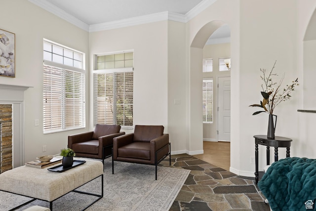 890 N Sky Mountain Ct, Hurricane, UT 84737 - living room with stone tile flooring, arched walkways, a high ceiling, healthy amount of natural light, and ornamental molding