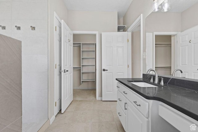 890 N Sky Mountain Ct, Hurricane, UT 84737 - full bathroom featuring a spacious closet, vanity, and tile patterned floors