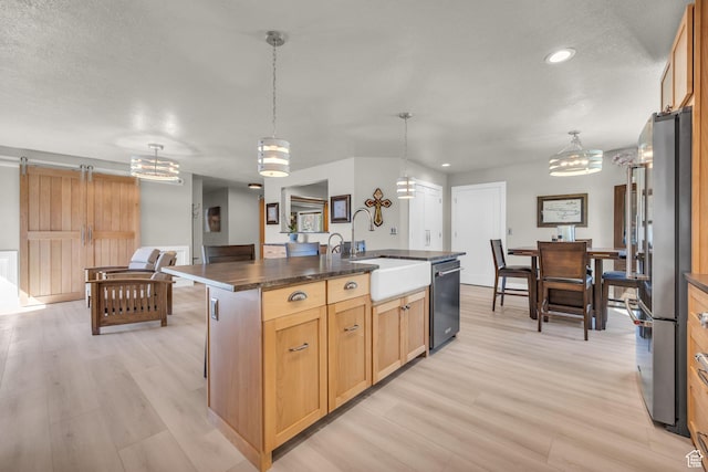 9185 S 200 W, Paradise, UT 84328 - kitchen featuring an inviting chandelier, a sink, light wood-style floors, and appliances with stainless steel finishes