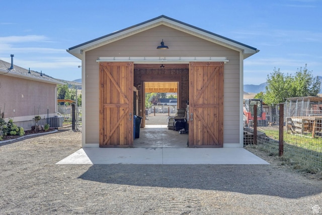 9185 S 200 W, Paradise, UT 84328 - view of outdoor structure featuring central air condition unit, an outdoor structure, fence, and a mountain view