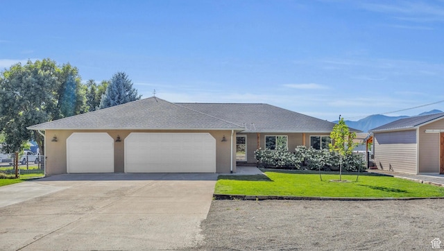 9185 S 200 W, Paradise, UT 84328 - ranch-style home featuring concrete driveway, an attached garage, a front yard, brick siding, and roof with shingles
