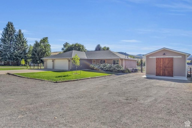 9185 S 200 W, Paradise, UT 84328 - ranch-style house featuring a storage unit, an outbuilding, driveway, a garage, and a front yard