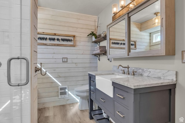9185 S 200 W, Paradise, UT 84328 - full bathroom with a shower with shower door, wooden walls, wood finished floors, toilet, and vanity