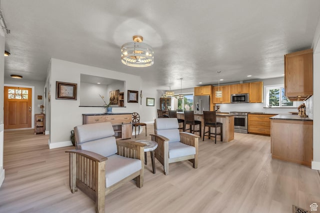 9185 S 200 W, Paradise, UT 84328 - living area with recessed lighting, baseboards, a chandelier, and light wood-type flooring