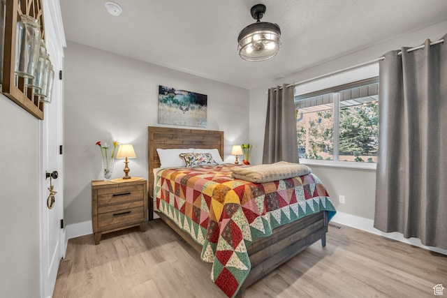9185 S 200 W, Paradise, UT 84328 - bedroom featuring light wood-type flooring, baseboards, and visible vents