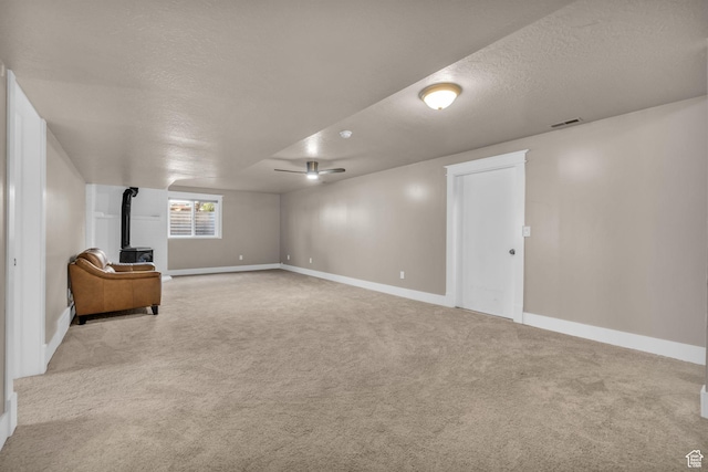 9185 S 200 W, Paradise, UT 84328 - basement featuring a textured ceiling, a wood stove, carpet, baseboards, and visible vents