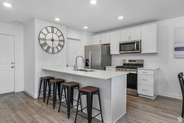 488 N Trident Dr, Saratoga Springs, UT 84045 - kitchen featuring a kitchen breakfast bar, visible vents, a sink, baseboards, and appliances with stainless steel finishes
