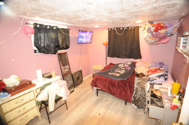 bedroom with wood finished floors