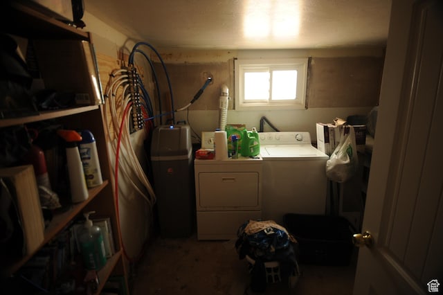 washroom with separate washer and dryer and laundry area