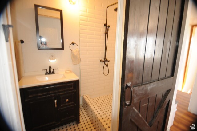 bathroom featuring vanity and tiled shower