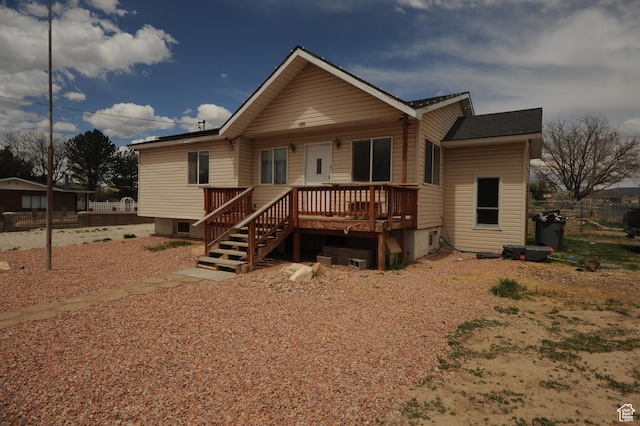 rear view of house featuring fence