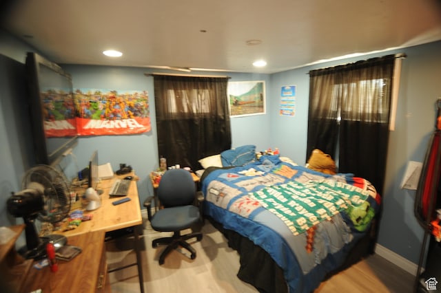 bedroom with wood finished floors and recessed lighting