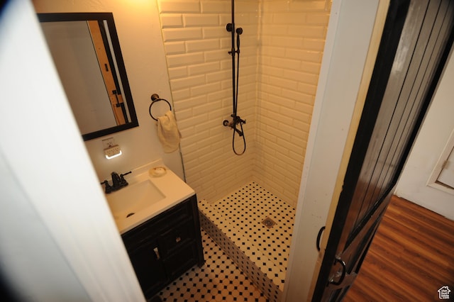 bathroom with a shower stall, vanity, and wood finished floors