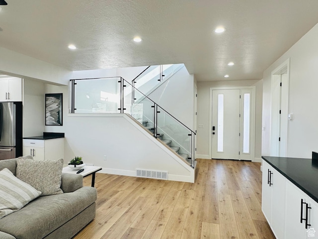 2747 S Country Club Way, Garden City, UT 84028 - living area featuring recessed lighting, light wood-style flooring, and stairway