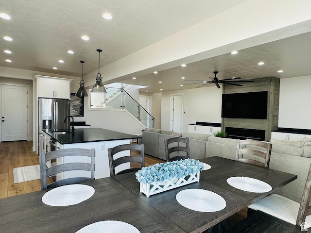2747 S Country Club Way, Garden City, UT 84028 - dining room with stairs, recessed lighting, dark wood-style floors, a ceiling fan, and a textured ceiling