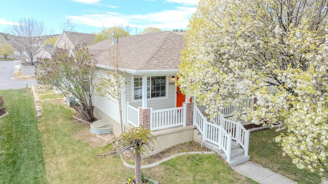 2976 E Saddle Rock Rd, Eagle Mountain, UT 84005 - view of front facade featuring a shingled roof, covered porch, and a front yard